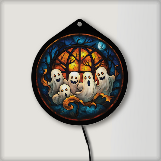 Cute ghost family faux stained glass LED sign in front of a glowing window design, lights off