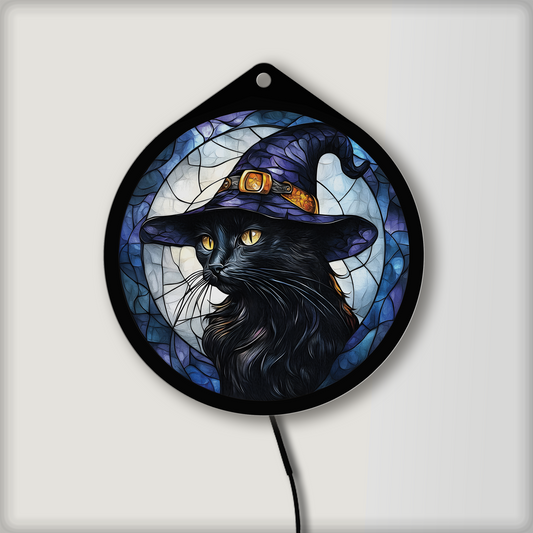Black cat witch hat LED sign glowing on a wall in a lit room