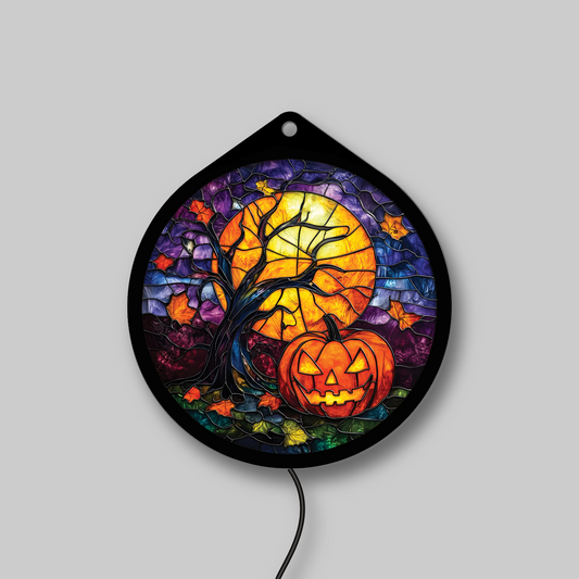 Pumpkin under a harvest moon faux stained glass LED sign, lights off