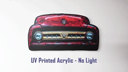 A die-cut acrylic wall sign depicting the front of a 1953 F100 grille with red body color with a distressed weathered finish. The sign is displayed against a plain white background with purple text below reading 'UV Printed Acrylic - No Light'.