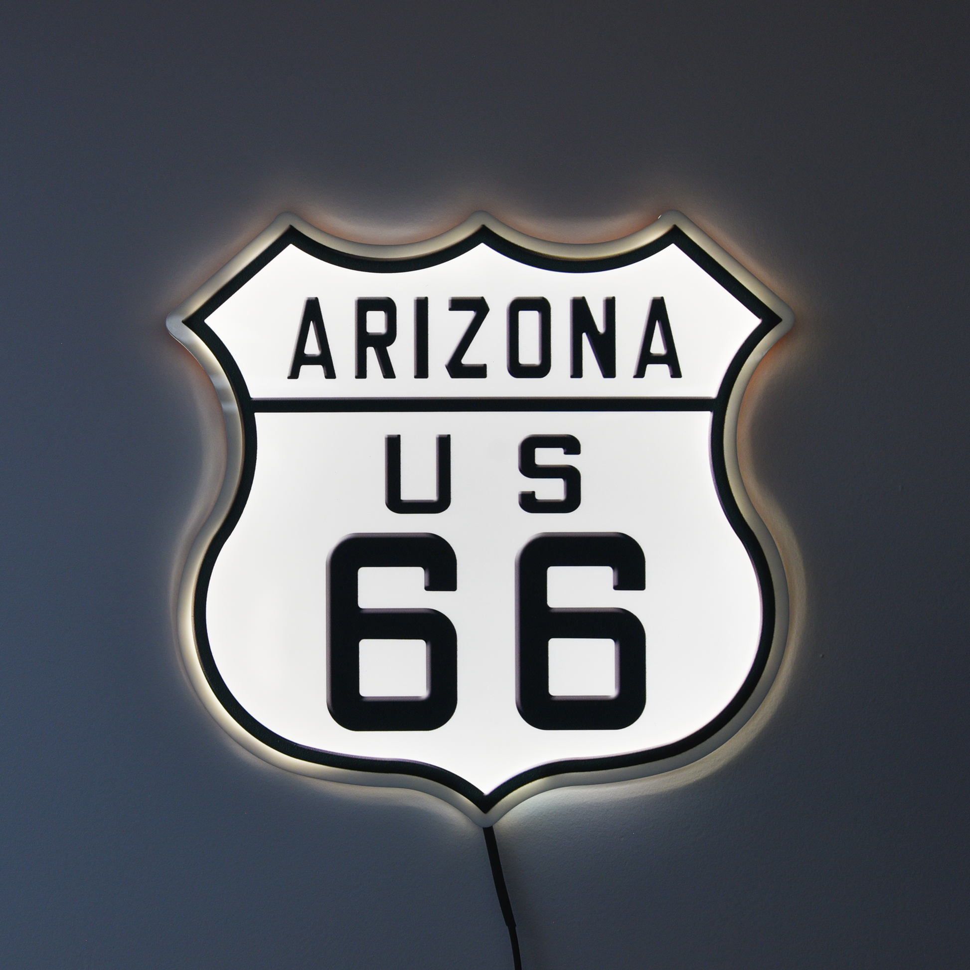 LED sign shaped like a highway shield with 'Arizona US 66' text on a dark background