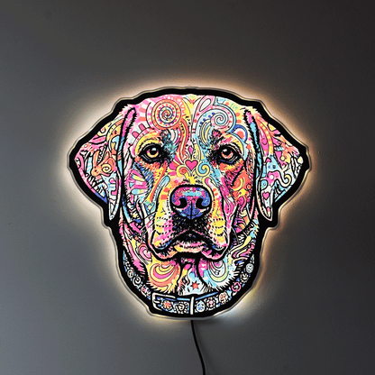 A colorful LED neon-style wall light shaped like an English Lab head, featuring a vibrant multicolor pattern on a black base, mounted against a dark gray wall with a warm glow around the edges.