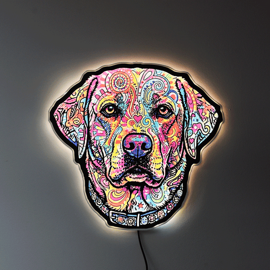 A colorful LED neon-style wall light shaped like an English Lab head, featuring a vibrant multicolor pattern on a black base, mounted against a dark gray wall with a warm glow around the edges.