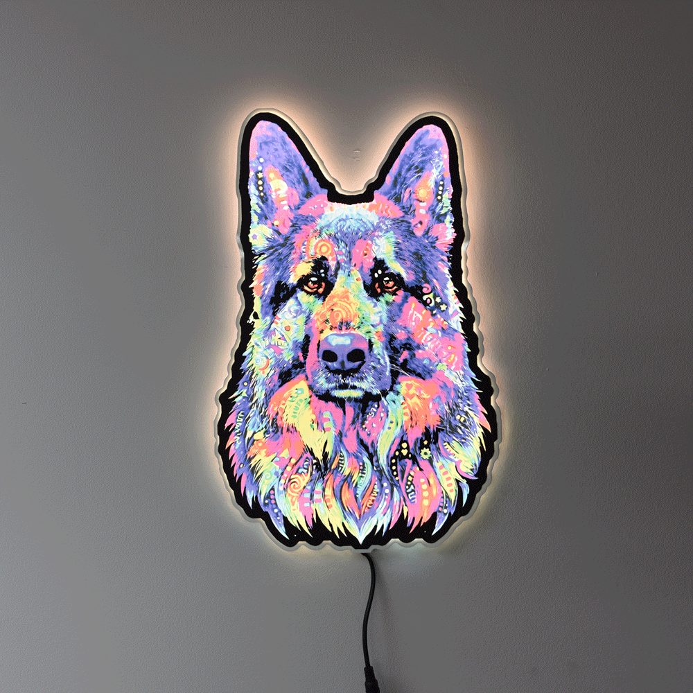 A colorful LED neon-style wall light shaped like a German Shepherd dog face, glowing with a multicolor neon pattern against a plain gray wall.