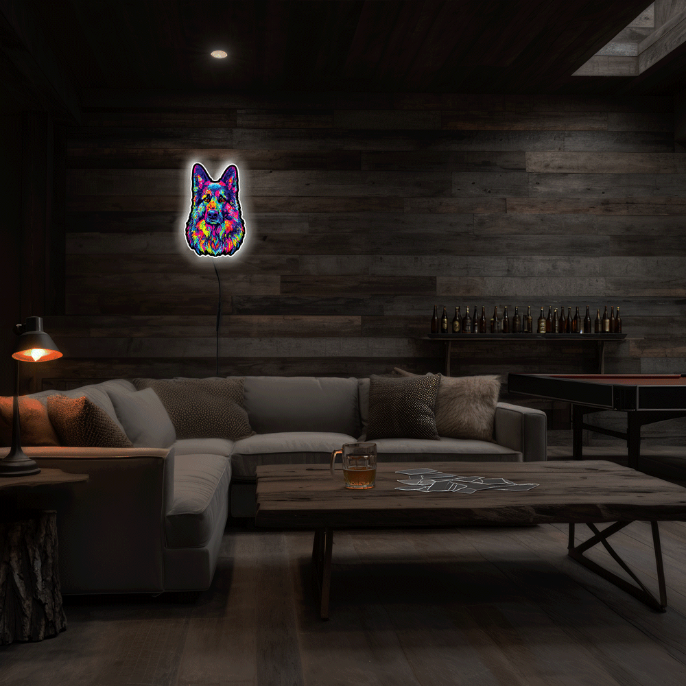 A colorful neon-style wall light shaped like a German Shepherd face hangs on a dark wood-paneled wall in a dimly lit living room with a sectional sofa, coffee table, and lamps.