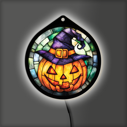 Jack-o'-lantern witch hat LED sign glowing with backlight on, purple hat and orange pumpkin lit