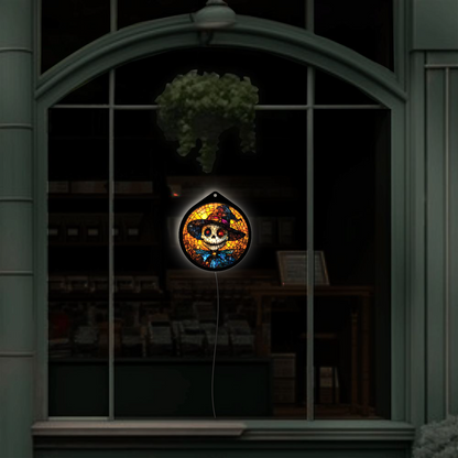 Pumpkin-head scarecrow sign unlit in a shop window display, wide view
