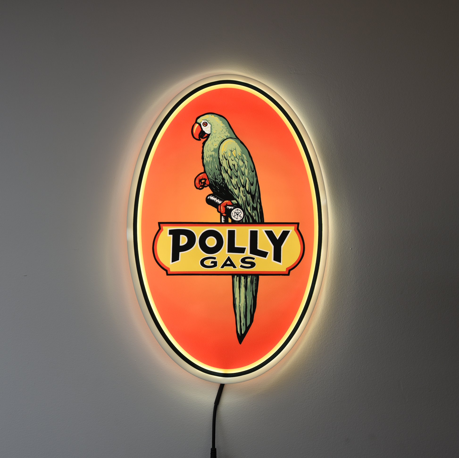 Vintage-style Polly Gas sign with a parrot on an orange background