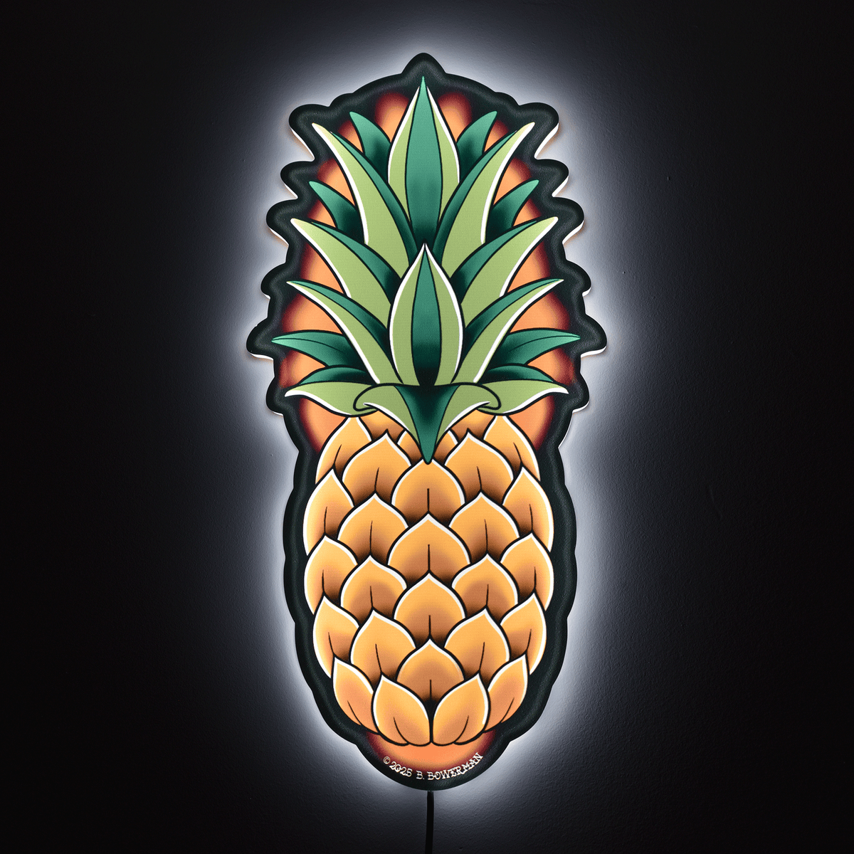 Original large size pineapple design by Bryce Bowerman wall light on in a dark room to show powerful illumination