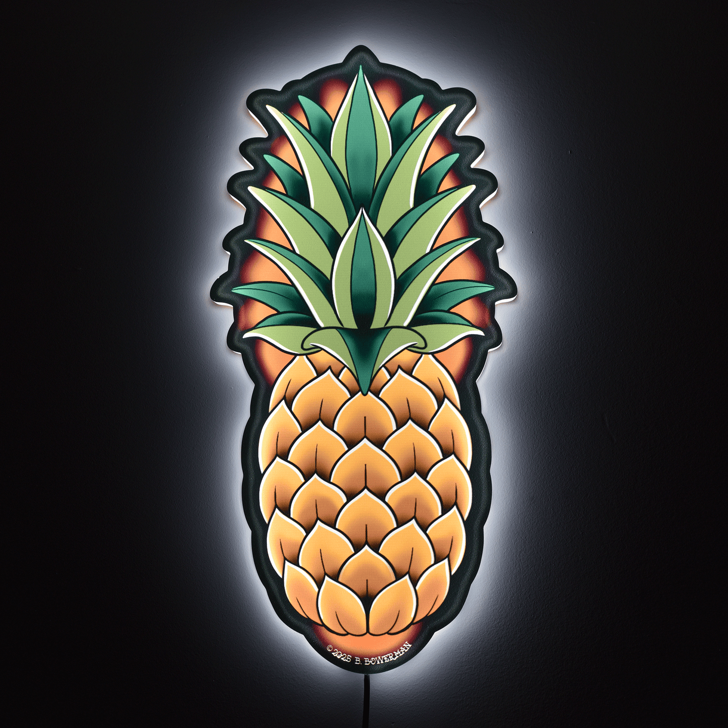 Original large size pineapple design by Bryce Bowerman wall light on in a dark room to show powerful illumination