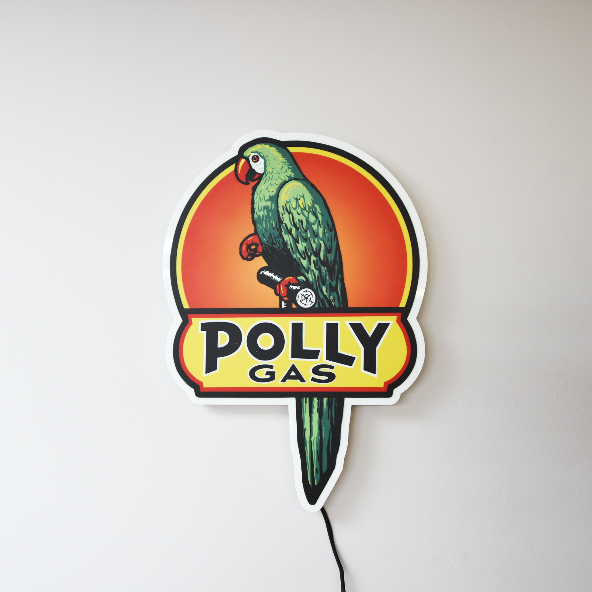 Polly Gas sign with a parrot design on a white background