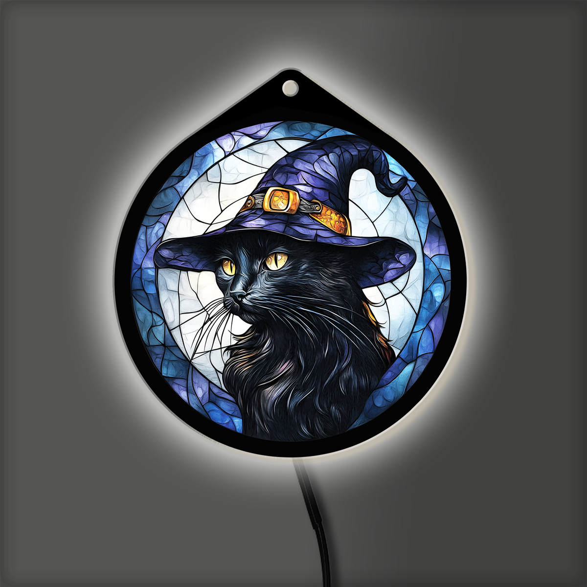 Black cat witch hat LED sign glowing on a dark wall at night