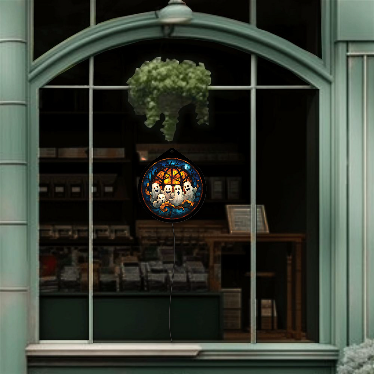 Ghost family sign displayed unlit, hanging in a shop window display
