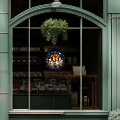 Ghost family sign displayed unlit, hanging in a shop window display