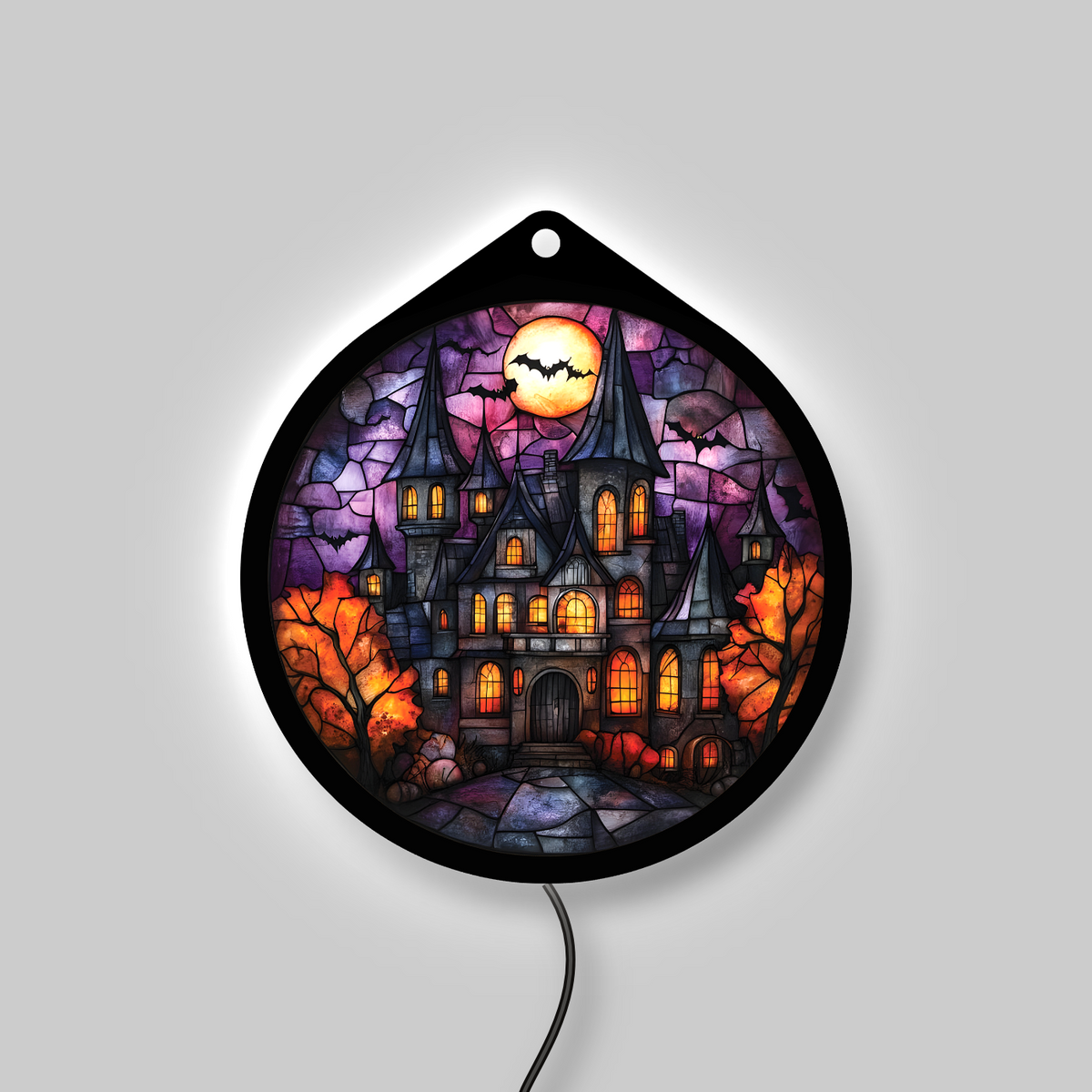 Haunted manor LED sign glowing with backlight on, amber windows lit
