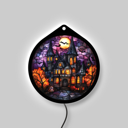 Haunted manor LED sign glowing with backlight on, amber windows lit