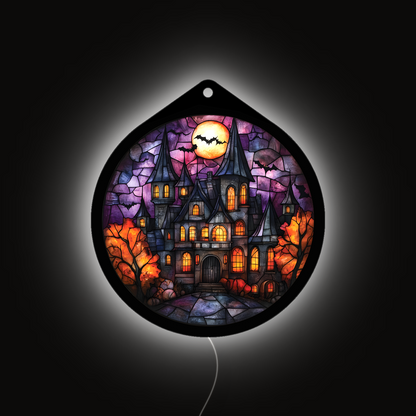 Haunted manor LED sign glowing brightly against a dark background