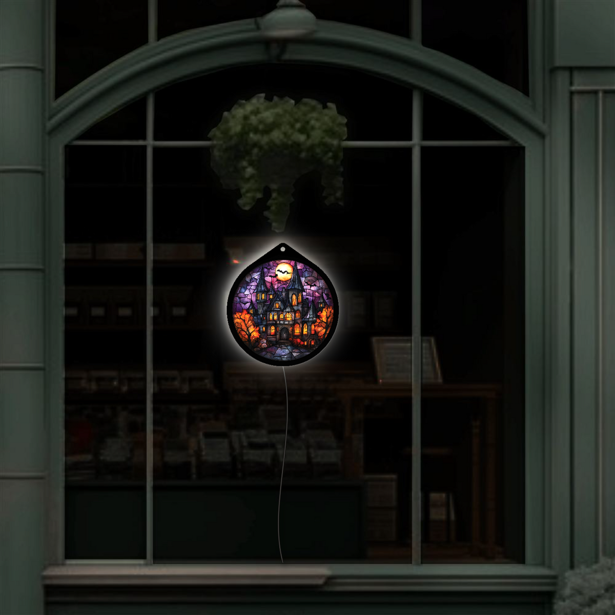 Haunted manor LED sign glowing, hanging in a shop window display at night