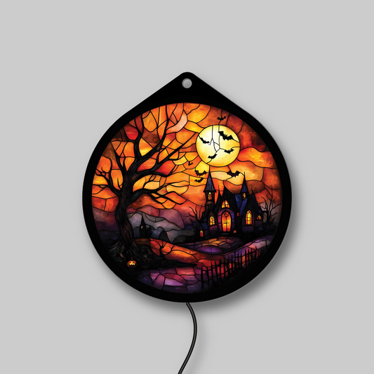 Haunted tree and harvest moon faux stained glass LED sign with jack-o'-lantern and bats, lights off