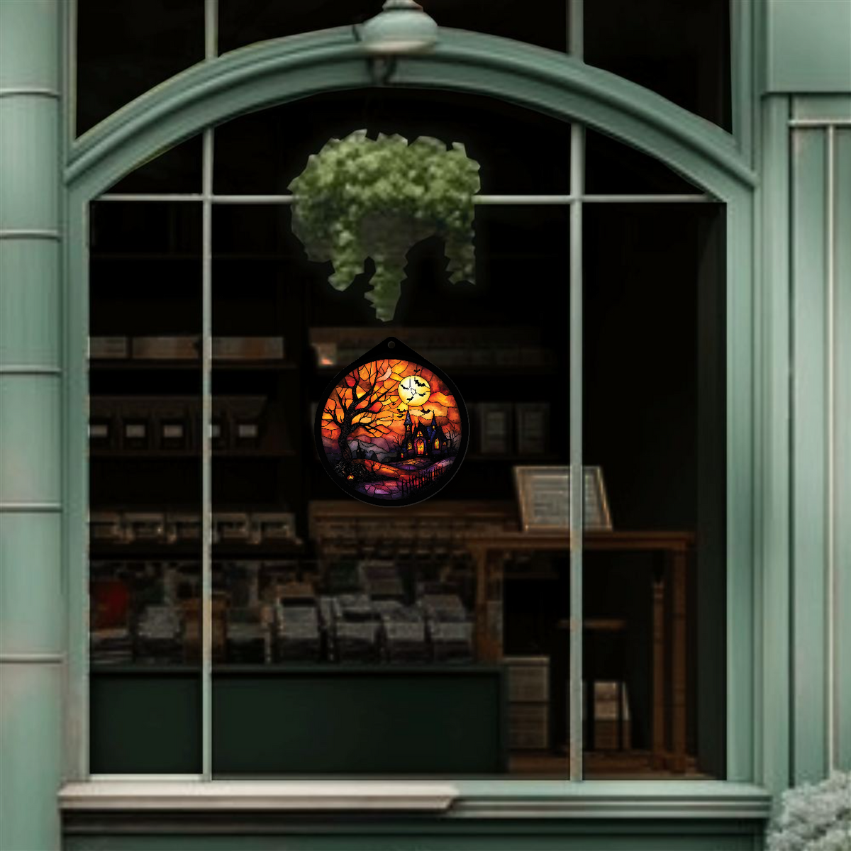 Haunted tree and moon sign unlit, hanging in a shop window display, alternate view