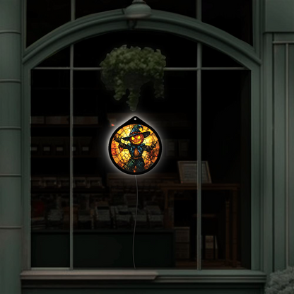 Skull scarecrow LED sign glowing brightly against a dark background, red eyes prominent