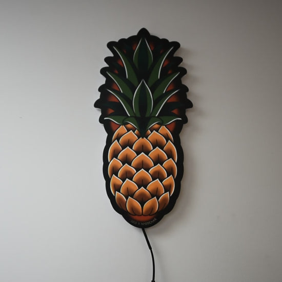 LED light on and off to illuminate  Original medium size Pineapple tattoo design by Bryce Bowerman in a room with lights on then off
