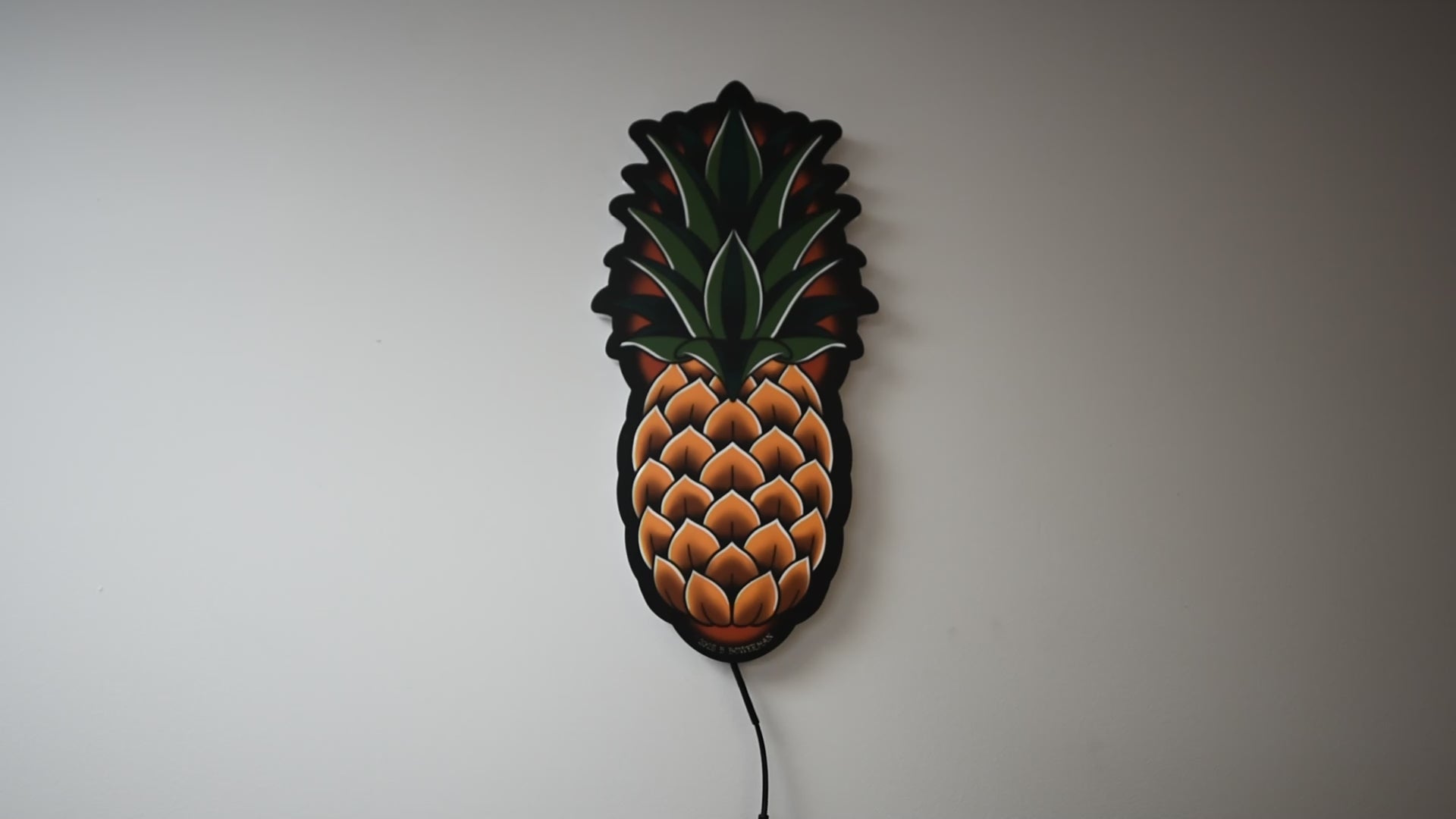 LED light on and off to illuminate  Original medium size Pineapple tattoo design by Bryce Bowerman in a room with lights on then off