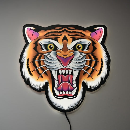Video showing Tiger Tattoo Tacker by Bryce Bowerman turned on and off in a lighted room and a dark room to demonstrate how well the art is highlighted whether it is on or off