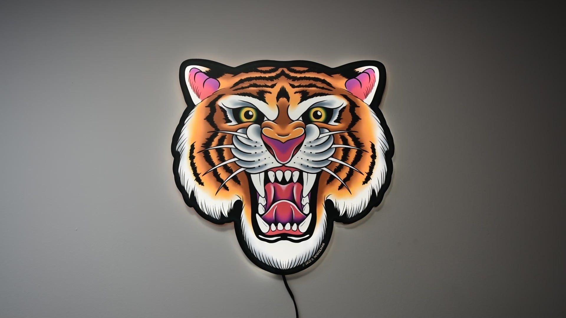 Video showing Tiger Tattoo Tacker by Bryce Bowerman turned on and off in a lighted room and a dark room to demonstrate how well the art is highlighted whether it is on or off